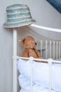 Colorful summer hat on bed frame with teddy bear plush toy Royalty Free Stock Photo