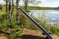 colorful summer landscape, paddle board drying on the shore of the lake Royalty Free Stock Photo