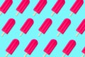 Summer pattern of pink popsicles on a blue background