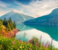 Colorful summer scene of Resia Reschensee lake. Resia village in the morning mist, Province of Bolzano - South Tyro, Italy,
