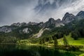 Colorful summer scene of side Vorderer Gosausee lake with forest and rocky hills at background in Austria Royalty Free Stock Photo