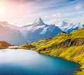 Colorful summer sunrise on Bachalpsee lake with Schreckhorn and Wetterhorn peacks on background.