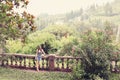 Colorful summer tree with woman standing and contemplating nature. Young girl in a sunglasses walking alone in a forest