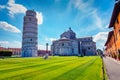 Colorful summer view of famous Leaning Tower. Superb morning scene with hundreds of tourists in Piazza dei Miracoli Square of Mir Royalty Free Stock Photo