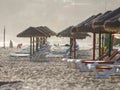 Colorful sun beds under straw umbrellas on the beach Royalty Free Stock Photo