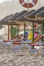 Colorful sun beds under straw umbrellas on the beach Royalty Free Stock Photo