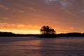 Colorful sunrise with clouds in the sky and frozen lake