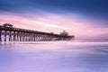 Colorful Sunrise with moving clouds over boardwalk in Myrtle Beach Royalty Free Stock Photo