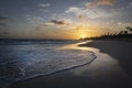 Sunrise over resort beach in Dominican Republic with couple walking in distance.