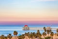A colorful sunrise over the Huntington Beach Pier in Huntington Beach, California, USA.