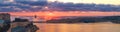 Colorful sunrise panorama with cruise ship in bay