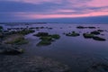 Colorful sunrise on rocky sea coast, long exposure Royalty Free Stock Photo