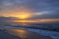 Colorful sunrise on the sea coast, waves, foam