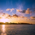 Colorful sunrise on the Tuscan coast in winter with the sun reflecting on the clouds and sea, shot with analogue film technique