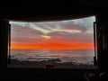 Colorful sunrise viewed from inside a camper van motorhome. Concept of alternative vacation and lifestyle people. Freedom and