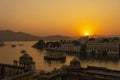 Colorful sunset above architecture and lake water in Udaipur, Rajasthan, India Royalty Free Stock Photo