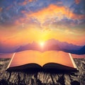 Colorful sunset above the sea on the pages of book