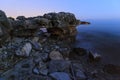 Enjoying the colorful sunset on a beach with rocks on the Adriatic Sea coast Istria Croatia Royalty Free Stock Photo