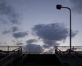 Colorful sunset sky above a pedestrian overpass. Contrastive dusk view. Royalty Free Stock Photo