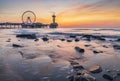 Colorful sunset on coastline, beach, pier and ferries wheel, Scheveningen, the Hague Royalty Free Stock Photo