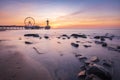 Colorful sunset on coastline, beach, pier and ferris wheel, Scheveningen, the Hague Royalty Free Stock Photo