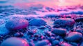 Colorful sunset light reflecting on wet beach stones Royalty Free Stock Photo