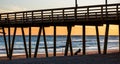 Colorful Sunset at ocean coast with silhouette of pier and photo Royalty Free Stock Photo