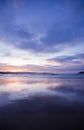 A colorful sunset over a beach with clouds reflecting in the water2 Royalty Free Stock Photo