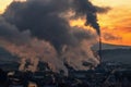 Colorful sunset over industrial city. Air pollution from chimney Royalty Free Stock Photo