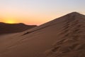 Colorful sunset over the Namib desert, Namibia, Africa. Scenic sand dunes in backlight in the Namib Naukluft National Park Royalty Free Stock Photo