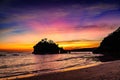 Colorful sunset over the ocean with purple sunrays. Island sunset. Sky during dusk. Crystal bay beach, Nusa Penida, Bali Royalty Free Stock Photo