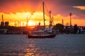 Colorful sunset over sea port and industrial cranes, Varna, Bulgaria. Sailing boat Royalty Free Stock Photo
