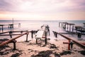 Colorful sunset over the sea shore. Old rusty boat berths. Long exposure smooth water waves effect