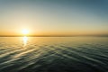 Colorful sunset over water surface, evening sun over the bay, summer sky without clouds Royalty Free Stock Photo