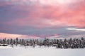 Colorful sunset over winter landscape with snow covered forest . Royalty Free Stock Photo