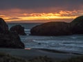 Sunset at sandy beach with sea stacks