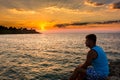 Colorful sunset in the sea and silhouette of traveler