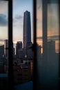 Sunset Cityscape Framed Through Window Bars with Prominent Skyscraper Royalty Free Stock Photo