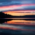 Colorful sunset sky reflects on the tranquil surface of the lake Royalty Free Stock Photo