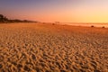 A colorful sunset or sunrise on the seaside with a sandy beach with impurities of volcanic ash. Mandrem, Goa, India Royalty Free Stock Photo