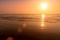 A colorful sunset or sunrise on the seaside with a sandy beach with impurities of volcanic ash. Mandrem, Goa, India Royalty Free Stock Photo