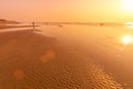 A colorful sunset or sunrise on the seaside with a sandy beach with impurities of volcanic ash. Mandrem, Goa, India Royalty Free Stock Photo