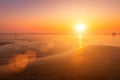 A colorful sunset or sunrise on the seaside with a sandy beach with impurities of volcanic ash. Mandrem, Goa, India Royalty Free Stock Photo