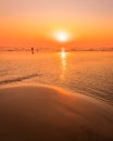 A colorful sunset or sunrise on the seaside with a sandy beach with impurities of volcanic ash. Mandrem, Goa, India Royalty Free Stock Photo