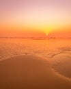 A colorful sunset or sunrise on the seaside with a sandy beach with impurities of volcanic ash. Mandrem, Goa, India Royalty Free Stock Photo