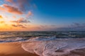 Colorful sunset with wave splashes on tbeach