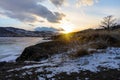 Colorful sunset on winter crack ice lake Baikal . Stunning sunset above the frozen surface of the lake Baikal Royalty Free Stock Photo