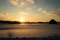 colorful sunset in winter over countryside fields covered in snow Royalty Free Stock Photo