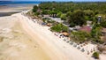 Colorful sunshades, lungers and seats on a sandy tropical beach on a small island (Gili Islands, Indonesia