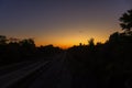 A colorful sunup above a small train station